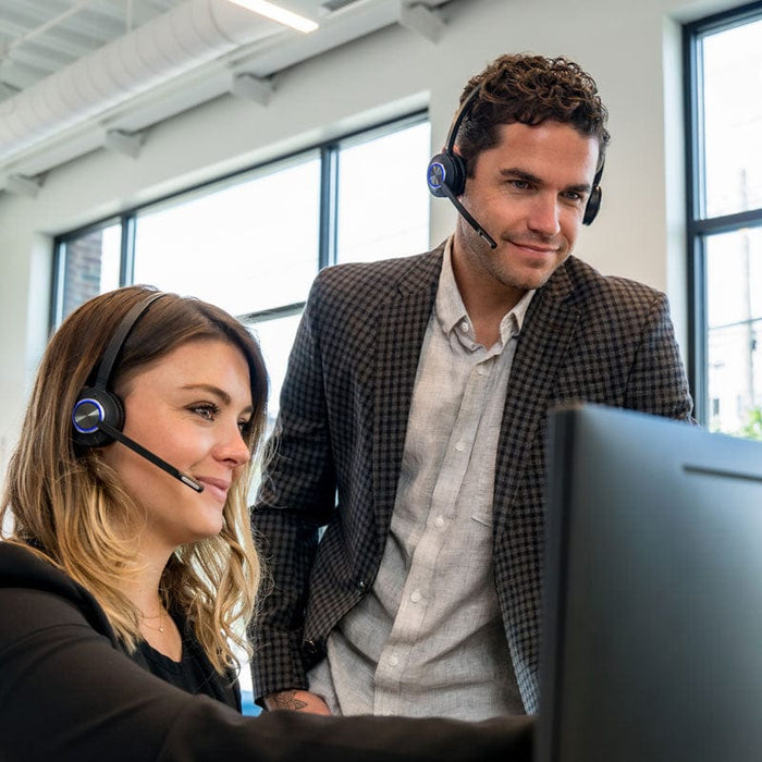 Office Workers using LH570 single ear wireless headset while training at computer